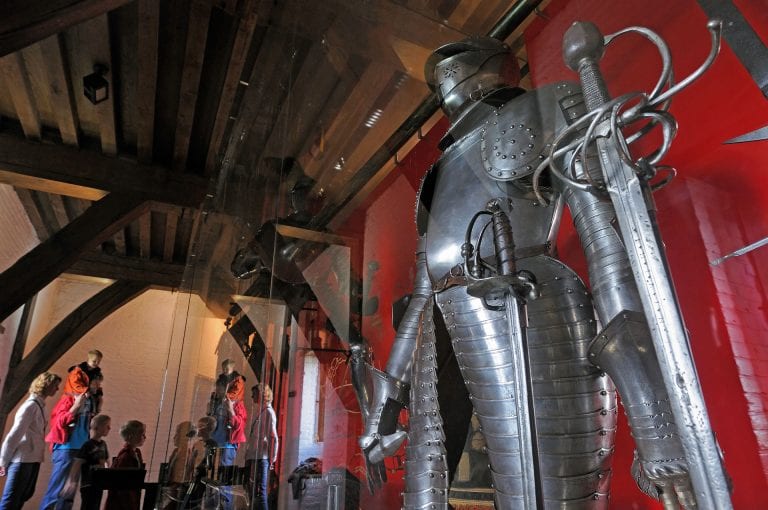 Knight armor and visitors in armory of Muiderslot