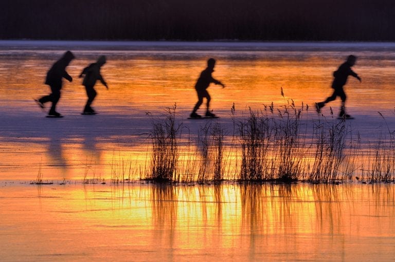 Ice skaters at sunset on the Ankeveense Plassen