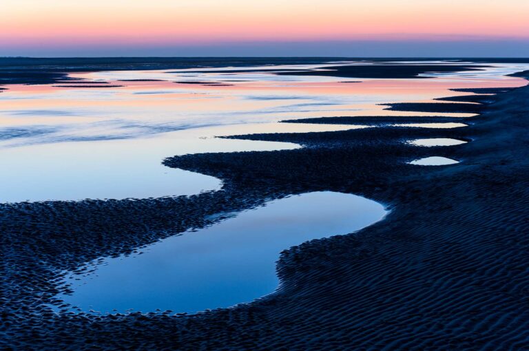 Low tide at a beach with sunset