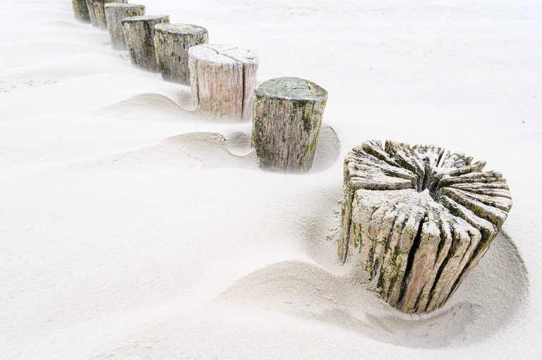 Beach poles almost under the sand