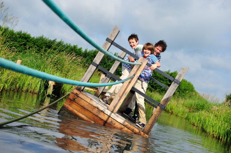 Father and two sons on a crooked pull raft