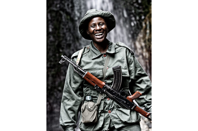 A cheerful laughing female ranger with a AK47 Kalashnikov