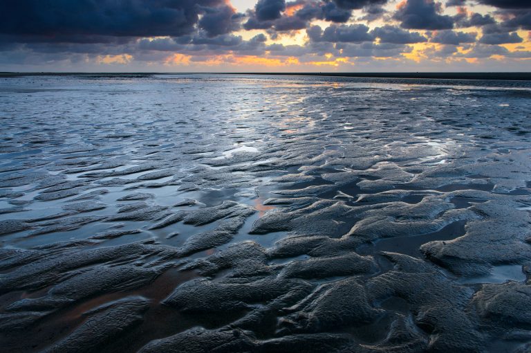 Kwade Hoek beach at low tide at sunset, with patterns.