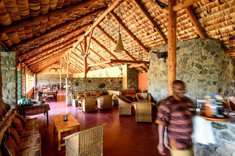 Main building of lodge with dining room and man walking