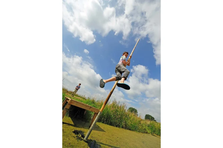 Boy pole vaulting