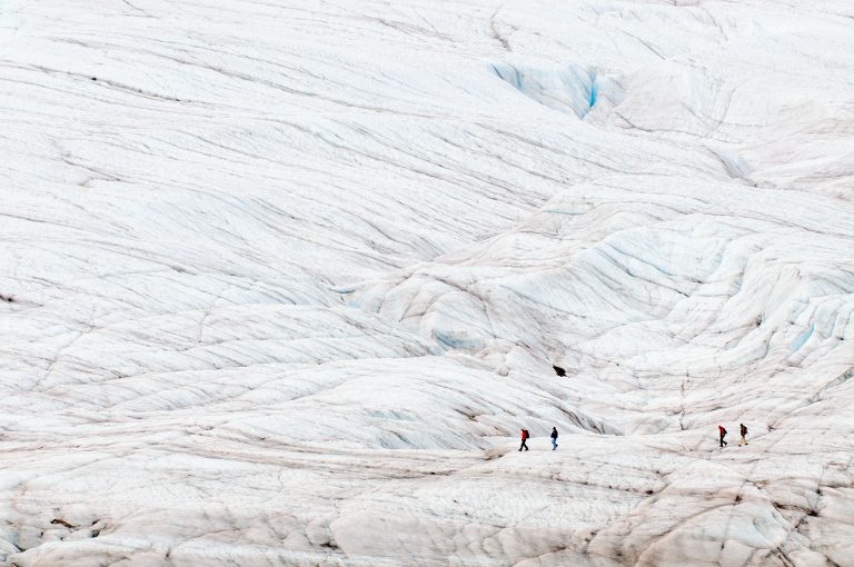 Hikers walk on the Root Glacier