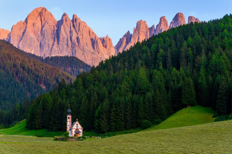San Giovanni church and in the background typical Dolomites mountains.