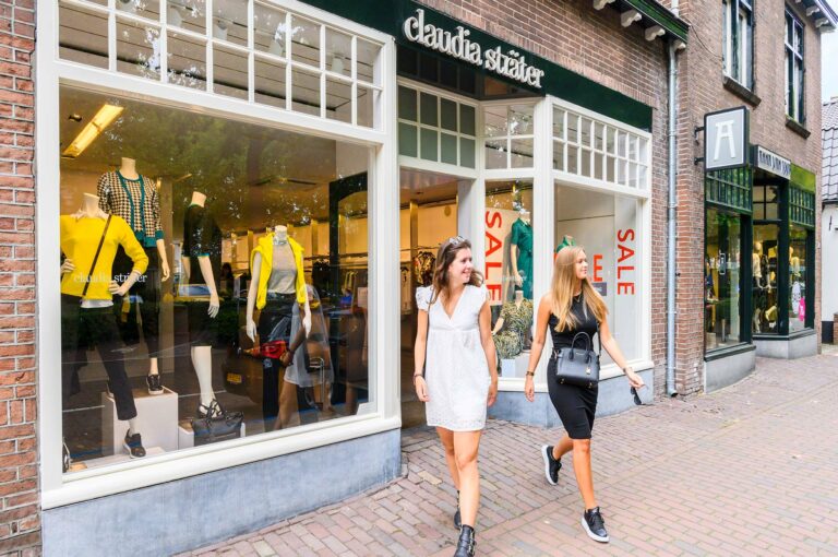 Shopping women coming out of a shop