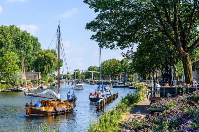 Boats on and terrace along the river Vecht in Weesp