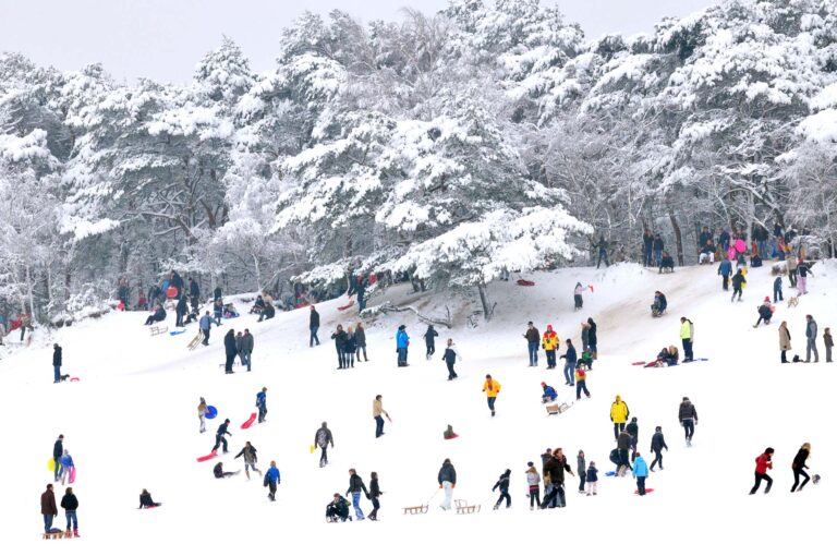 People sledding from a slope.
