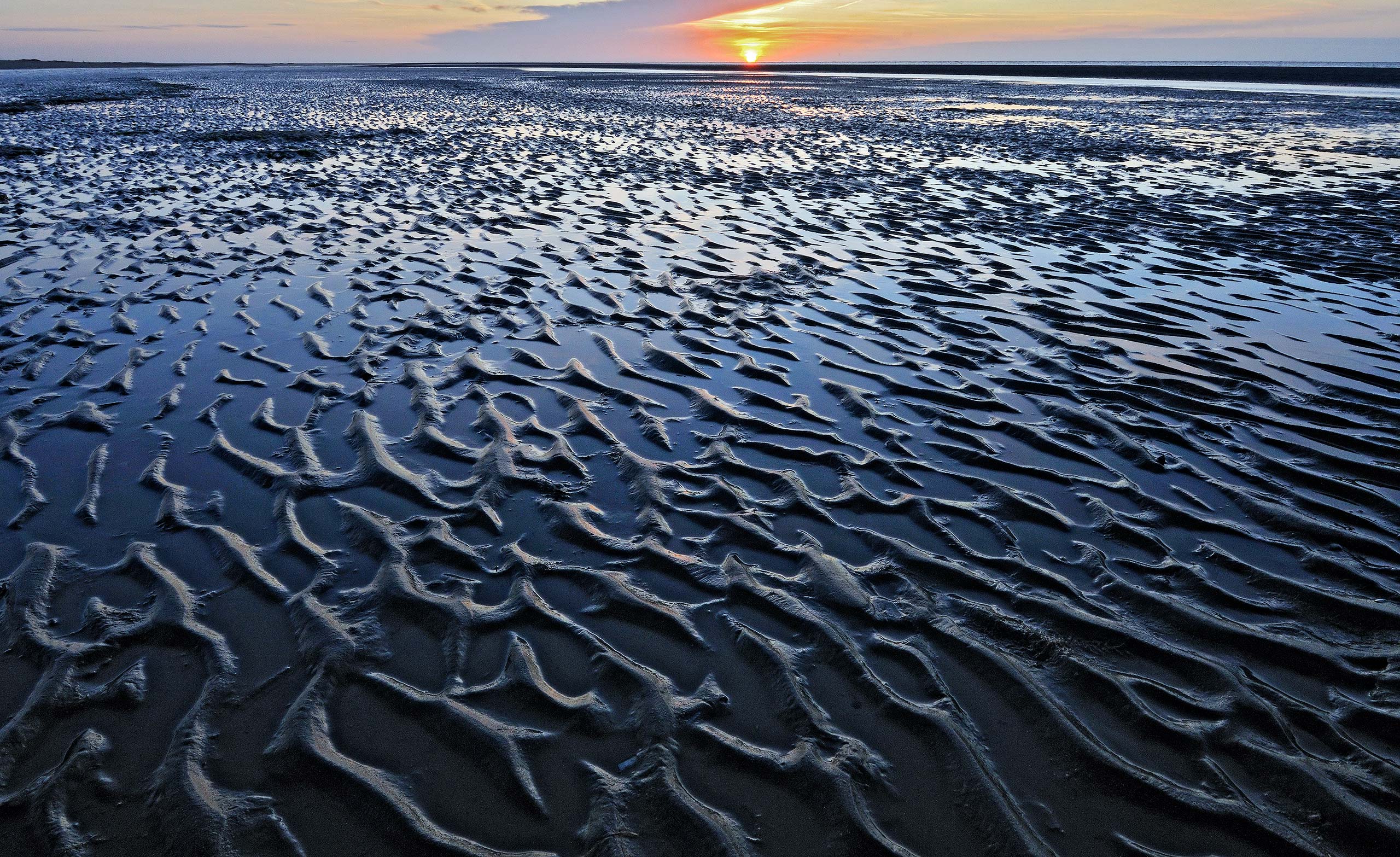 Patterns on the beach of Kwade Hoek at sunset.