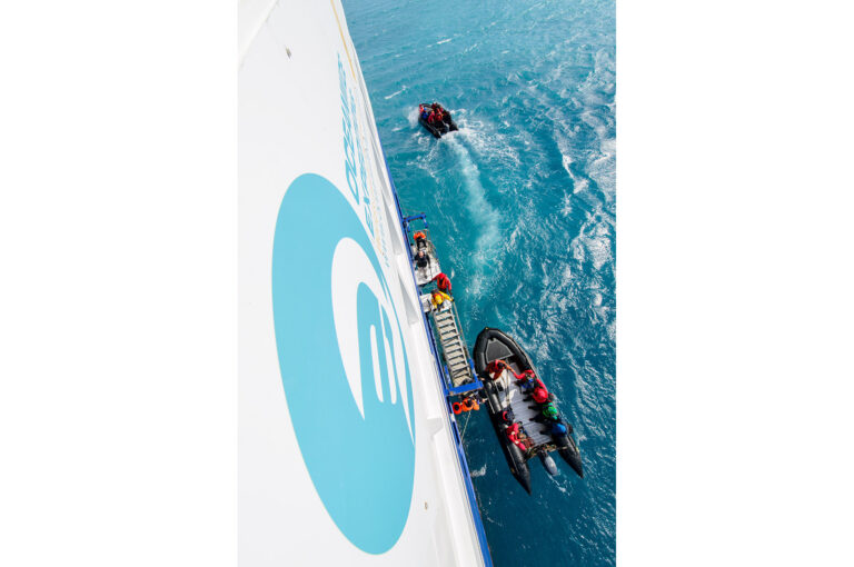 Zodiacs at the stairway of ship and leaving