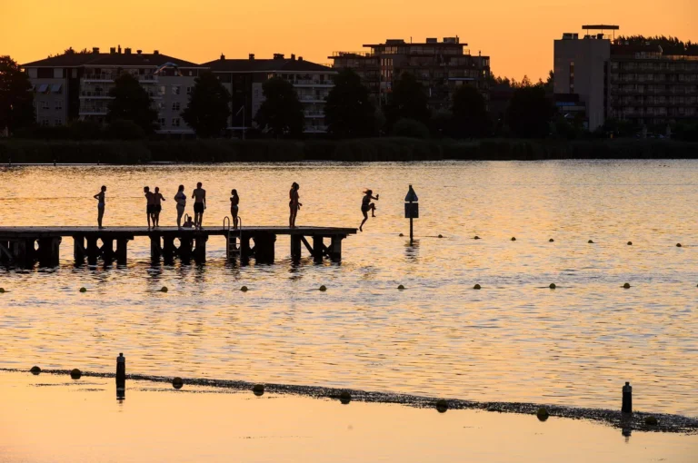 Children jumping from a swimming jetty.