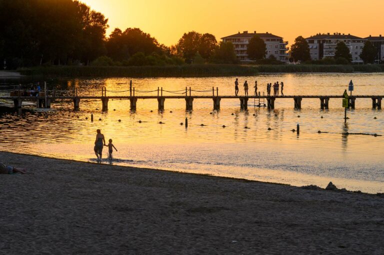 Swimming jetty and people on jetty and beach.